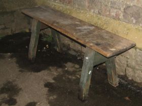 An old rustic pine pig type bench with through jointed splayed supports (af), 47 cm high x 123 cm
