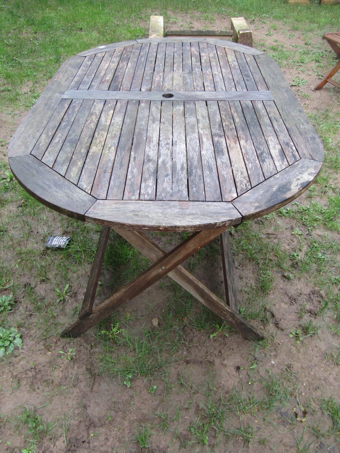 A weathered contemporary teak garden table of oval form with slatted top, raised on X framed - Image 3 of 9