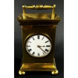 A small 19th century brass mantle clock, the circular enamel dial with a small fusee movement and