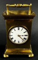 A small 19th century brass mantle clock, the circular enamel dial with a small fusee movement and