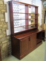 A bespoke mahogany bookcase cupboard the lower section enclosed by a pair of fielded panelled