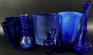 A collection of eight Bristol Blue glassware vases in varying designs.