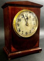 An inlaid mahogany Edwardian mantle clock, with silvered dial, pendulum