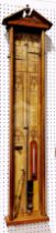 A 19th century Admiral Fitzroy barometer with oak case, the back plate with printed detail and