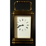 A 19th century brass carriage clock with enamelled dial, with eight day striking movement, currently
