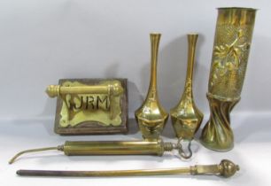 A Victorian brass toilet roll holder initialled JRM screwed to a wooden plinth, a piece of Trench