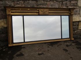 A Regency overmantle mirror, the gilt frame with turned moulded supports enclosing three mirror