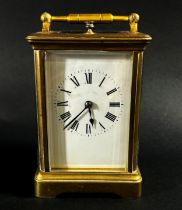 A brass carriage clock with eight day striking movement with repeat, currently running