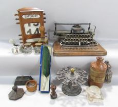 A distressed vintage Blickensderfer No 7 typewriter, a wooden desk top adjustable calendar , a