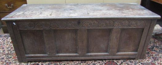 A long 18th century oak coffer, the front elevation enclosed by four panels beneath a repeating