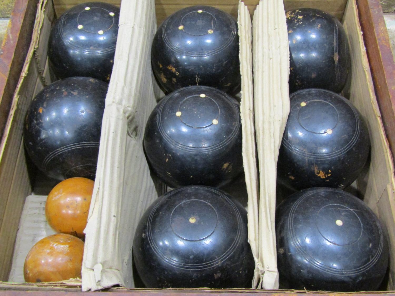 A cased set of lawn bowls, 8 large balls in ebony together with two smaller boxwood examples - Image 2 of 4