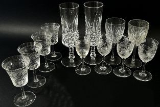 Six cut glass wine glasses with facetted cut stems, together with further wine glasses , Hock