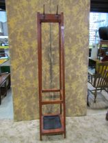 A simple wooden stained hallstand of square cut form