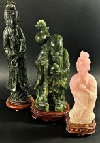 A large Chinese carved green jadeite figure of Guanyin, raised on fixed hardwood stand, 41cm high,