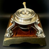 A Victorian silver table lighter with central reservoir on three shell supports, together with a