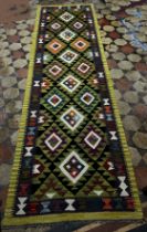 A Maimana Kilim Runner with a lime green border around a field of stepped diamond medallions 292 x