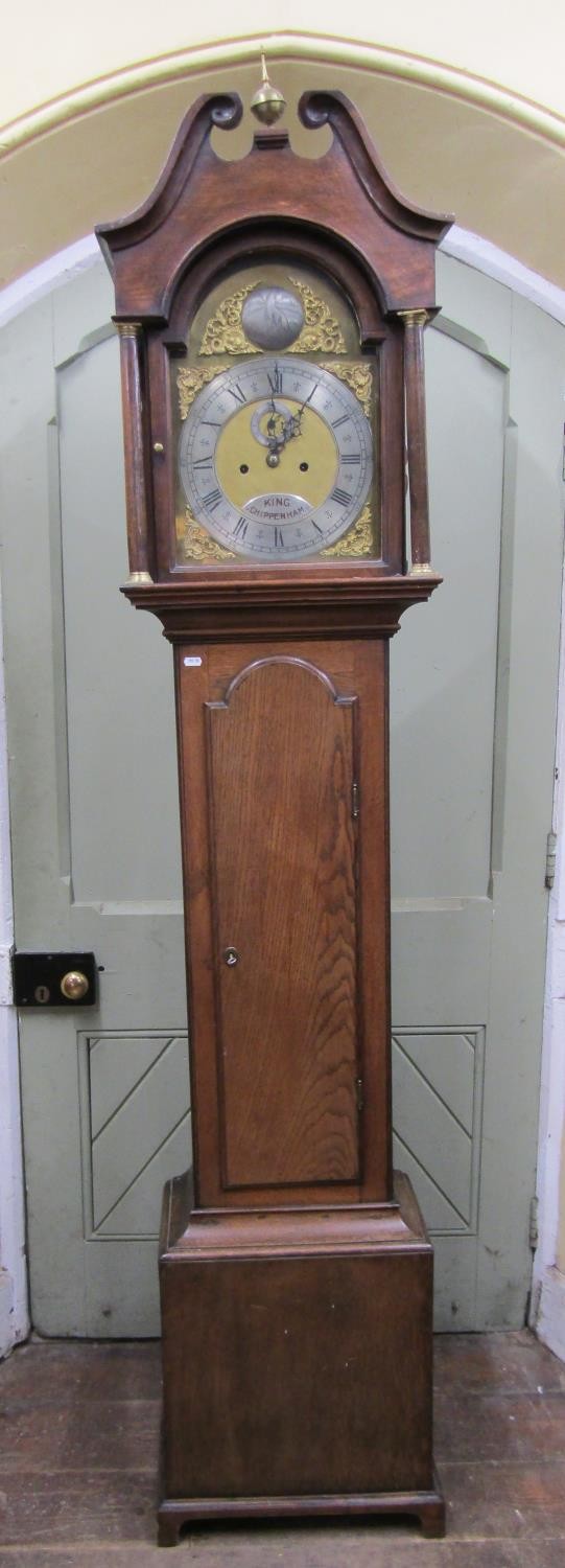 A 19th century oak longcase clock the hood with swan neck pediment enclosing a broken arch brass
