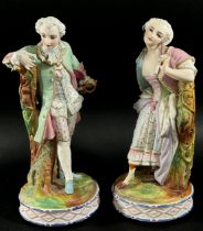 Two pairs of continental porcelain figures, one with hand painted detail showing male and female