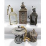 A collection of five lanterns in varying stages of weathered distress.