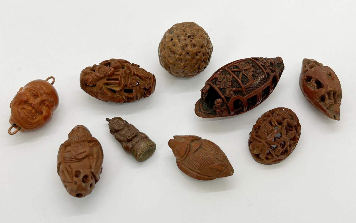 Collection of seven carved Chinese hediao nuts