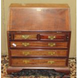 A miniature mahogany bureau in the Georgian style the fall flap enclosing a concave fitted interior,