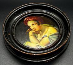 A 19th century continental painted and lacquered papier-mâché patch box cover, decorated with a