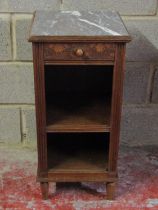 A continental oak bedside table with inset marble top over a frieze drawer with organic detail and
