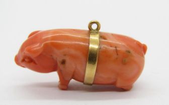Yellow metal mounted carved coral pig charm, 3cm L approx, 8.4g (back legs af)
