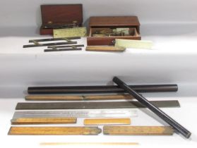 A selection of vintage rulers, rollers, and weighing scales.