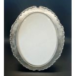An Edwardian oval silver picture frame, glazed with a silk back, Birmingham 1907, H.W. Ltd for Henry