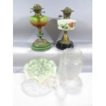 Two 19th century oil lamp bases, a pressed glass shade, a chimney and a Vaseline glass floral