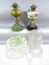 Two 19th century oil lamp bases, a pressed glass shade, a chimney and a Vaseline glass floral