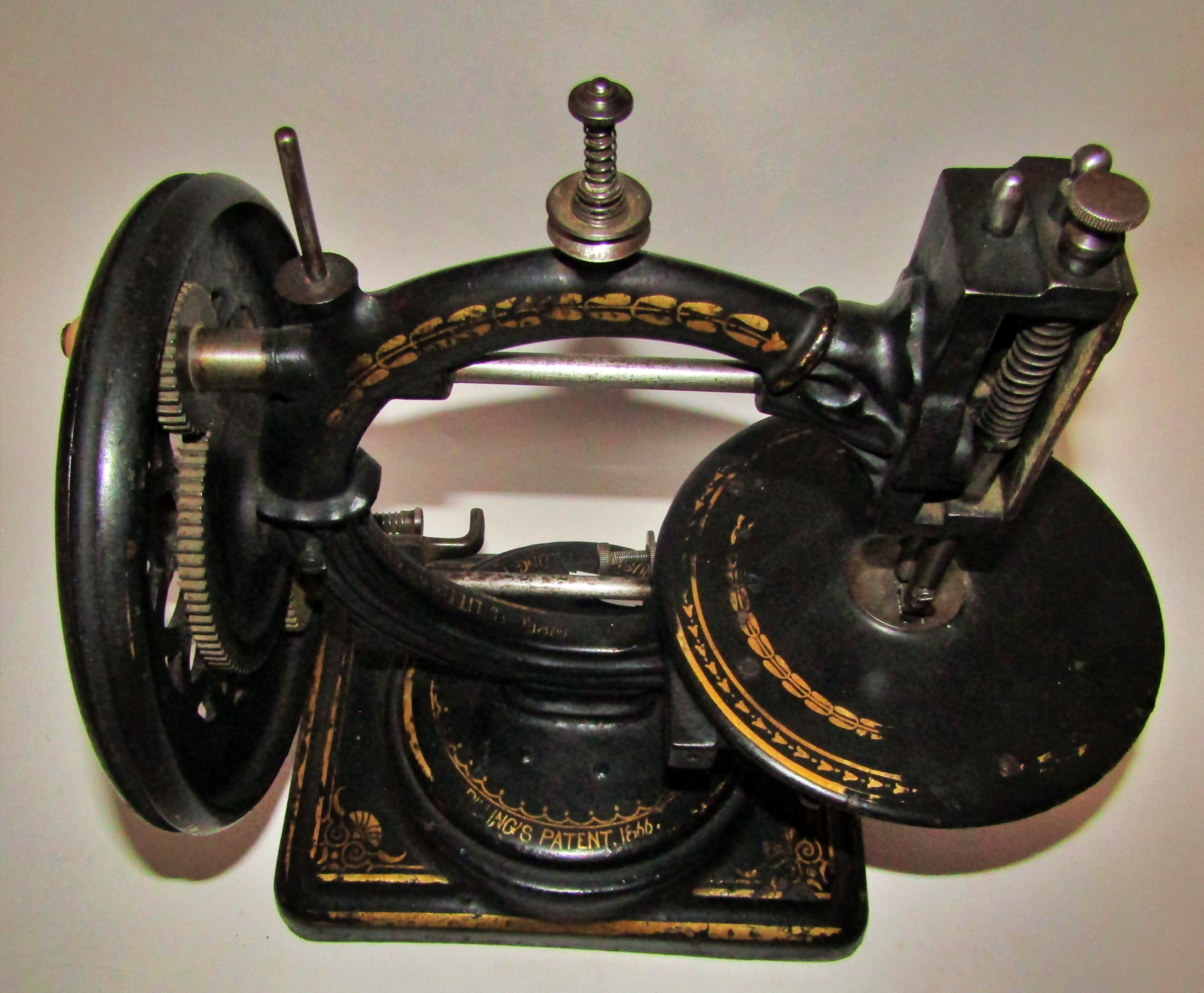 A scarce Nussey & Pilling 'Little Stranger' Victorian sewing machine with gilt decoration, on metal - Image 8 of 13