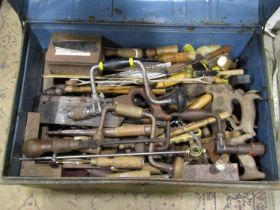 A steel trunk containing a good miscellaneous selection of hand tools, braces, bits, handsaws,