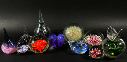 A collection of 37 20th century glass paperweights, each containing a unique central display of