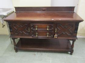 A Waring & Gillow Ltd Edwardian Jacobean style oak dresser base, the two central drawers flanked