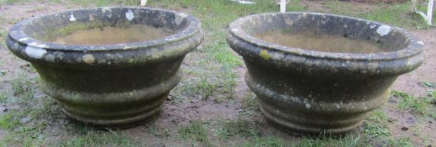 A pair of weathered cast composition stone circular tapered and ribbed garden planters 60 cm