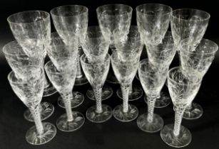 A suite of good quality cut glass drinking glasses with foliate decoration, on quadruple helix