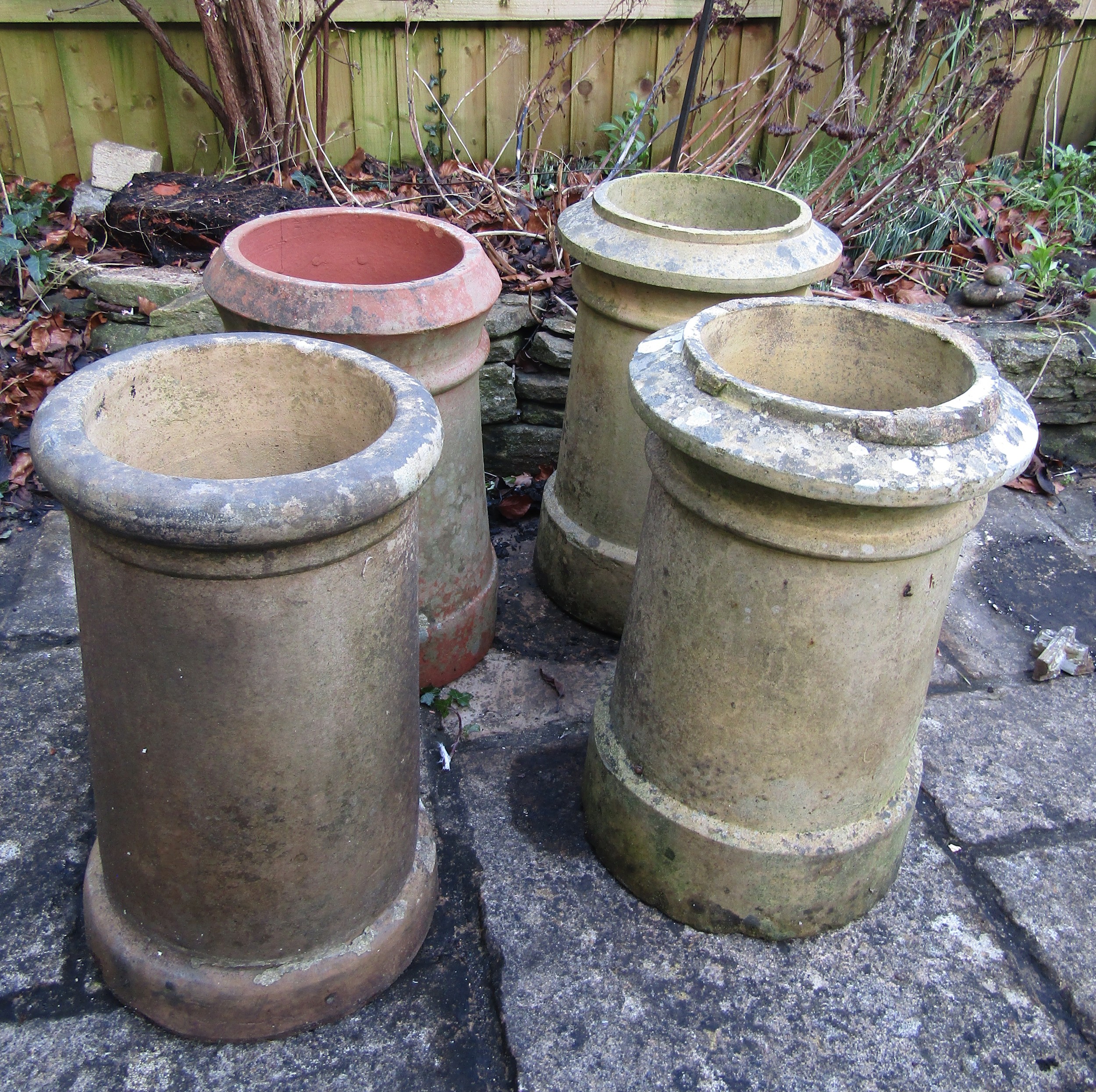Four weathered chimney pots, slight variation in height and design, 47cm tall max (af)