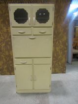 A vintage Remploy floor standing kitchen cabinet with painted finish enclosed by an arrangement of