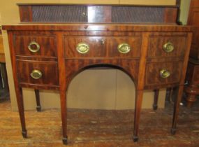 A Regency mahogany bow fronted sideboard enclosing drawer and cupboards, the raised back with