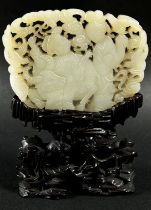 A Chinese carved pale mutton fat coloured jade / jadeite panel, pierced and carved with a figure and