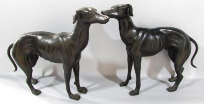 A pair of cast bronze greyhounds, 29cm x 36cm approx.