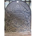 A heavy cast iron fire back of arched form, decorated with the heraldic / armorial of the British