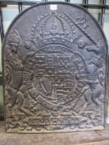 A heavy cast iron fire back of arched form, decorated with the heraldic / armorial of the British