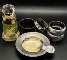 a selection of silver ware including four napkin rings, a small Armada dish, a caddy spoon and a
