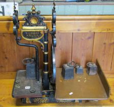 A pair of Victorian painted cast iron shop weighing scales with gilt painted highlighted detail