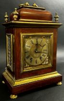 A late 19th century Georgian style bracket clock, the rosewood case with applied brass detail, the