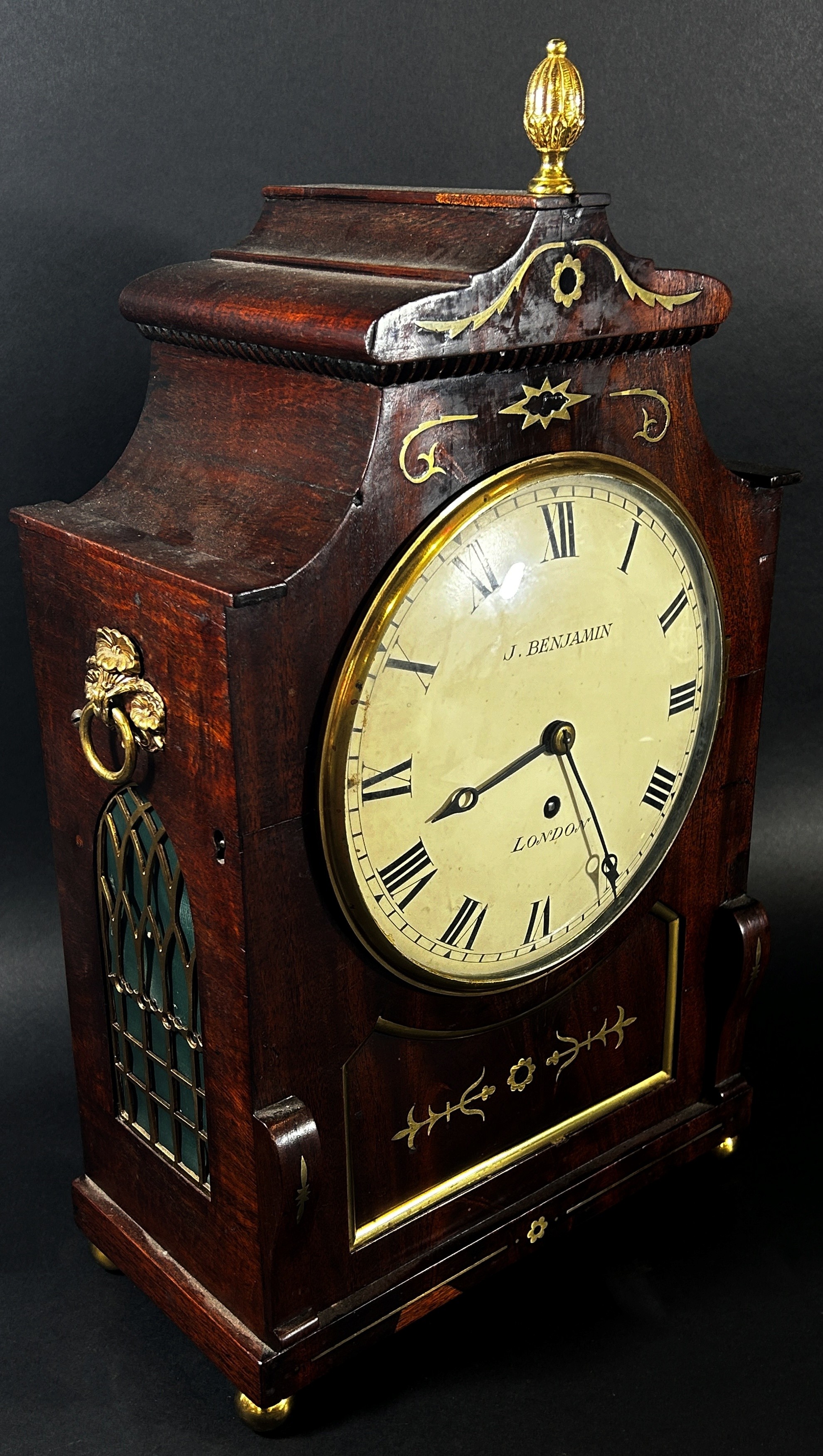 A Regency mahogany bracket clock the case with inlaid brass detail, enclosing a convex painted dial,