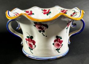 A French vase with scrolled handles and fluted neck and with hand painted floral detail